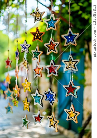 Colorful hanging star decorations can add a vibrant touch to your outdoor living area 133385812