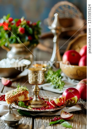 Still life with apples and pomegranates on a table, symbolizing autumn abundance and festivities 133385824