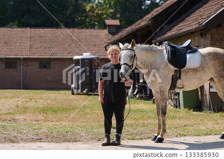 Girl with her horse in the countryside, a young rider and her equine friend, outdoor scene with natural light, equestrian lifestyle, rural setting, friendship and care. Girl with her horse in the countryside, a young rider and her equine friend, outdoor scene with natural light, equestrian lifestyle, rural setting, friendship and care. 133385930