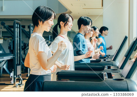 Men and women walking at the gym Men and women walking at the gym 133386069