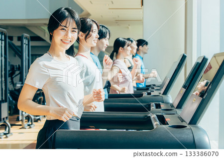 Men and women walking at the gym Men and women walking at the gym 133386070