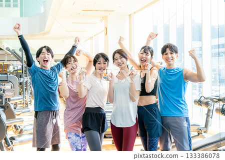 Men and women exercising at a fitness gym 133386078