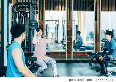 Men and women exercising at a fitness gym 133386085