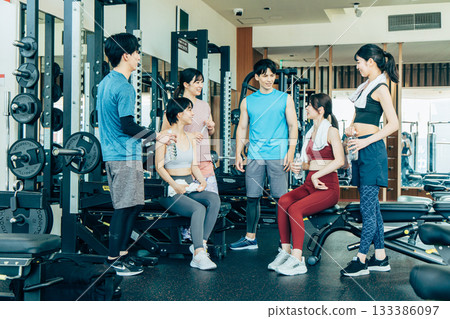 Men and women exercising at a fitness gym 133386097
