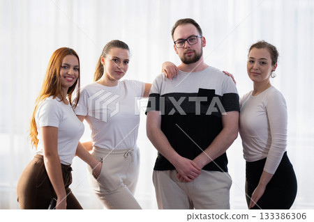 Group of confident young adults standing together in casual outfits, smiling and posing for the camera in a bright indoor setting. Concept of friendship, teamwork, confidence, and positive Group of confident young adults standing together in casual outfits, smiling and posing for the camera in a bright indoor setting. Concept of friendship, teamwork, confidence, and positive 133386306