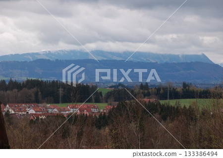 A mountain range is visible in the distance, with a town in the foreground 133386494