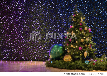 A gorgeously illuminated Christmas tree A gorgeously illuminated Christmas tree 133387706