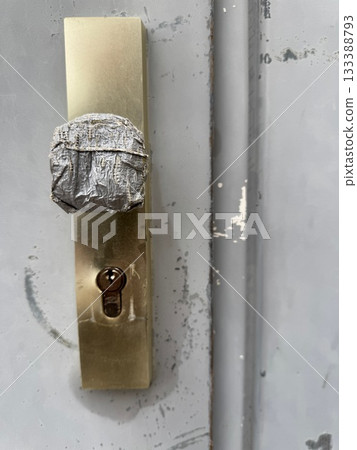 Broken Door Handle Wrapped in Tape 133388793