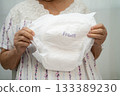 Asian senior woman patient wearing adult incontinence diaper pad in hospital. 133389230