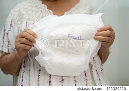 Asian senior woman patient wearing adult incontinence diaper pad in hospital. 133389230