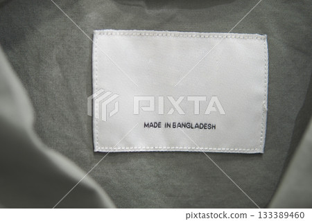 Tag showing country of origin on clothing fabric, made in bangladesh Tag showing country of origin on clothing fabric, made in bangladesh 133389460