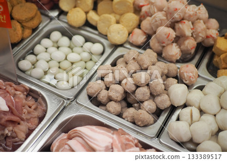 Variety of fresh meats and fish balls displayed in a market Variety of fresh meats and fish balls displayed in a market 133389517