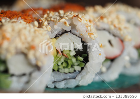 Fresh sushi rolls topped with sesame seeds 133389550