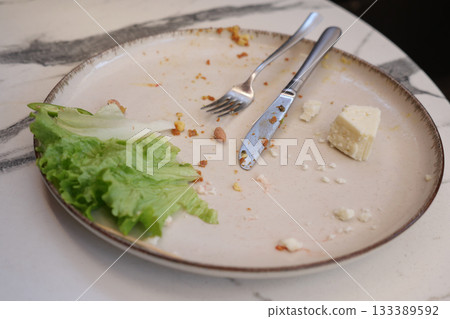 Used plate after a meal in a restaurant 133389592