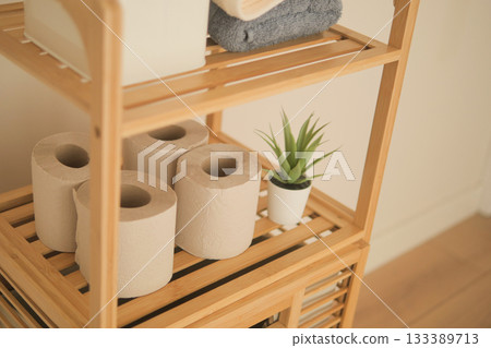 Towel and toilet paper storage in a tidy bathroom shelf Towel and toilet paper storage in a tidy bathroom shelf 133389713