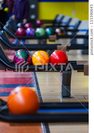 Colorful bowling balls lined up at a bowling tournament Colorful bowling balls lined up at a bowling tournament 133390643