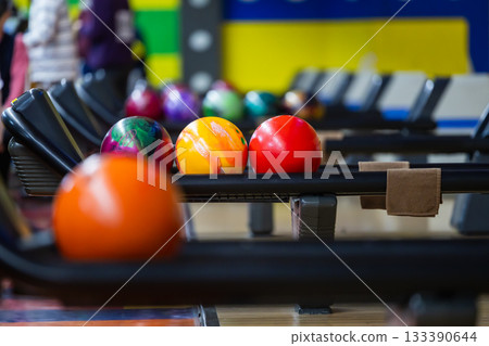 Colorful bowling balls lined up at a bowling tournament Colorful bowling balls lined up at a bowling tournament 133390644