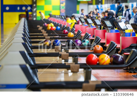 Colorful bowling balls lined up at a bowling tournament Colorful bowling balls lined up at a bowling tournament 133390646