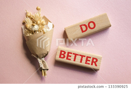 Do better symbol. Wooden blocks with words Do better. Beautiful pink background with bouquet of flowers. Business and Do better concept. Copy space. Do better symbol. Wooden blocks with words Do better. Beautiful pink background with bouquet of flowers. Business and Do better concept. Copy space. 133390925