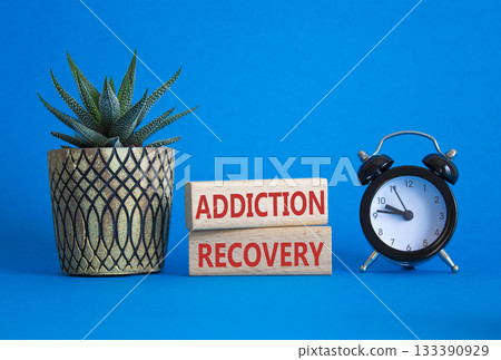 Addiction Recovery symbol. Concept words Addiction Recovery on wooden blocks. Beautiful blue background with alarm clock and succulent. Medicine and Addiction Recovery concept. Copy space. Addiction Recovery symbol. Concept words Addiction Recovery on wooden blocks. Beautiful blue background with alarm clock and succulent. Medicine and Addiction Recovery concept. Copy space. 133390929