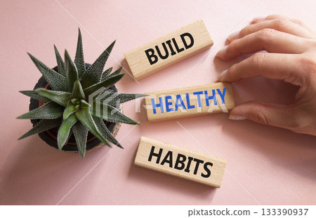 Healthy habits symbol. Concept word Build Healthy habits on wooden blocks. Doctor hand. Beautiful pink background with succulent plant. Healthy lifestyle and Healthy habits concept. Copy space 133390937