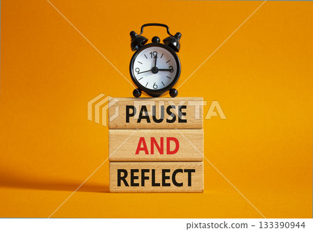 Pause and Reflect symbol. Concept words Pause and Reflect on wooden blocks. Beautiful orange background with alarm clock. Business and Pause and Reflect concept. Copy space. 133390944