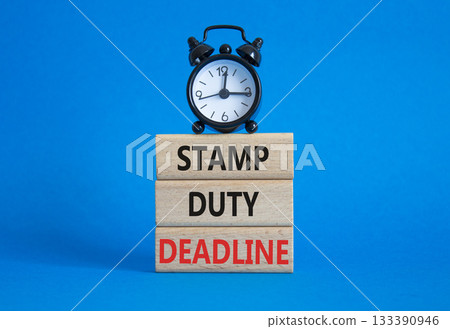 Stamp Duty Deadline symbol. Concept words Stamp Duty Deadline on wooden blocks. Beautiful blue background with alarm clock. Business and Stamp Duty Deadline concept. Copy space. Stamp Duty Deadline symbol. Concept words Stamp Duty Deadline on wooden blocks. Beautiful blue background with alarm clock. Business and Stamp Duty Deadline concept. Copy space. 133390946