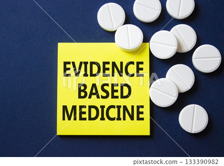 Evidence Based Medicine symbol. Concept word Evidence Based Medicine on yellow note. Beautiful deep blue background with pills. Medicine and Evidence Based Medicine concept. Copy space 133390982
