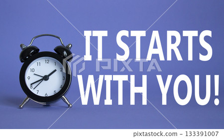 It starts with you symbol. Beautiful purple background with alarm clock. Business and It starts with you concept. Copy space. 133391007