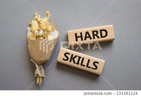 Hard skills symbol. Wooden blocks with words Hard skills. Beautiful grey background with bouquet of flowers. Business and Hard skills concept. Copy space. Hard skills symbol. Wooden blocks with words Hard skills. Beautiful grey background with bouquet of flowers. Business and Hard skills concept. Copy space. 133391128