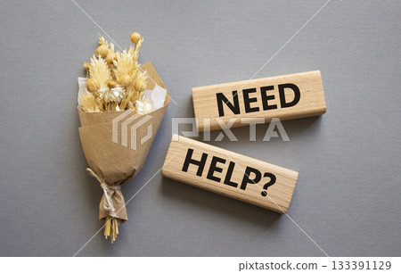 Need Help symbol. Concept word Need Help on wooden blocks. Beautiful grey background with bouquet of flowers. Business and Need Help concept. Copy space Need Help symbol. Concept word Need Help on wooden blocks. Beautiful grey background with bouquet of flowers. Business and Need Help concept. Copy space 133391129