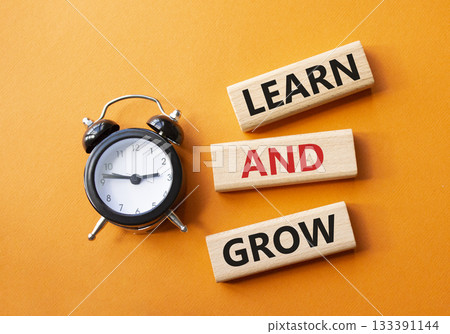 Learn and grow symbol. Concept words Learn and grow on wooden blocks. Beautiful orange background with alarm clock. Business and Learn and grow concept. Copy space. Learn and grow symbol. Concept words Learn and grow on wooden blocks. Beautiful orange background with alarm clock. Business and Learn and grow concept. Copy space. 133391144
