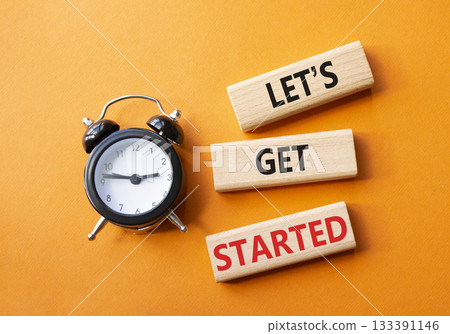 Lets get started symbol. Concept words Lets get started on wooden blocks. Beautiful orange background with alarm clock. Business and Lets get started concept. Copy space. Lets get started symbol. Concept words Lets get started on wooden blocks. Beautiful orange background with alarm clock. Business and Lets get started concept. Copy space. 133391146