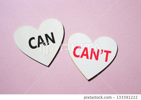 Can or Cant symbol. Concept word Can or Cant on wooden hearts. Beautiful pink background. Business and Can or Cant concept. Copy space 133391222