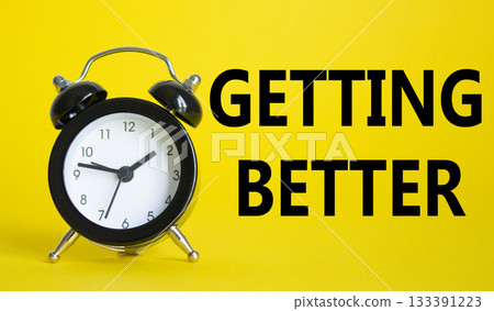 Getting better symbol. Beautiful yellow background with alarm clock. Business and Getting better concept. Copy space. 133391223