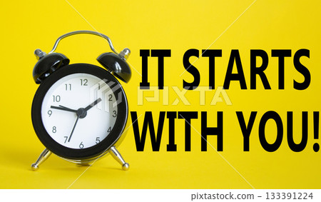 It starts with you symbol. Beautiful yellow background with alarm clock. Business and It starts with you concept. Copy space. 133391224