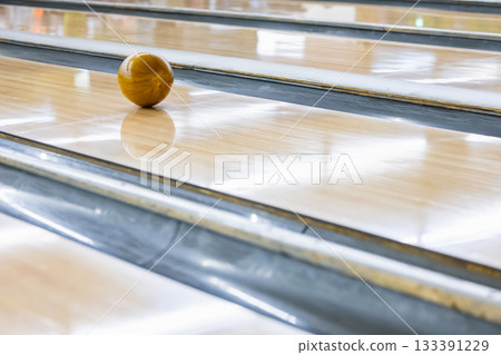 A ball running down a bowling lane A ball running down a bowling lane 133391229