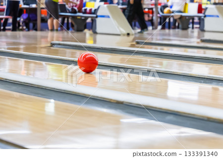 A ball running down a lane in a bowling tournament 133391340