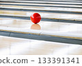 A ball running down a lane in a bowling tournament 133391341