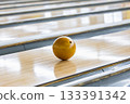 A ball running down a lane in a bowling tournament 133391342