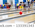 A ball running down a lane in a bowling tournament 133391343