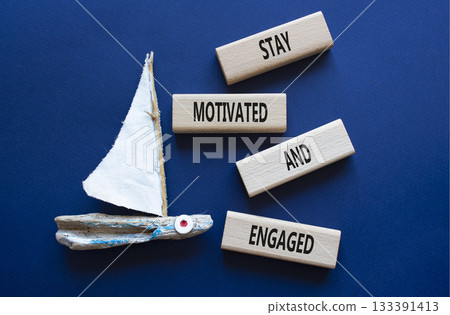 Stay Motivated and Engaged symbol. Concept words Stay Motivated and Engaged on wooden blocks. Beautiful deep blue background. Business concept. Copy space Stay Motivated and Engaged symbol. Concept words Stay Motivated and Engaged on wooden blocks. Beautiful deep blue background. Business concept. Copy space 133391413