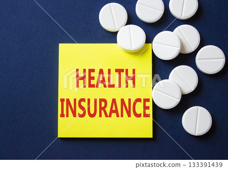 Health Insurance symbol. Concept word Health Insurance on yellow note. Beautiful deep blue background with pills. Medicine and Health Insurance concept. Copy space 133391439