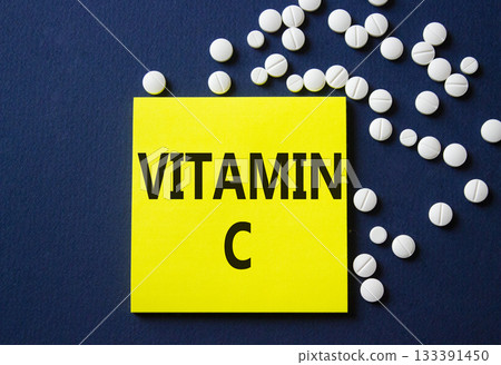 Vitamin C symbol. Concept word Vitamin C on yellow note. Beautiful deep blue background with pills. Medicine and Vitamin C concept. Copy space 133391450