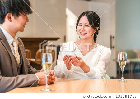 A man proposing and a woman receiving a jewelry case with a ring 133391713
