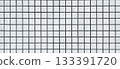 Background texture photo of an exterior wall with white square tiles and black grid joints 133391720