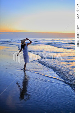 She looks at the sunset sea She looks at the sunset sea 133391896