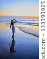 She looks at the sunset sea 133391925