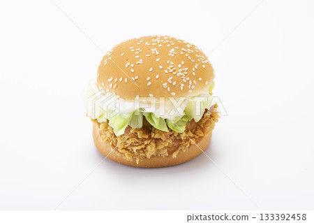 crisp chicken burger with tomato onion cheese lettuce isolated 133392458