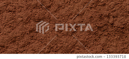 Fine cocoa powder texture in rich brown color creating a natural culinary background ideal for dessert design, baking concepts and product packaging visuals Fine cocoa powder texture in rich brown color creating a natural culinary background ideal for dessert design, baking concepts and product packaging visuals 133393718